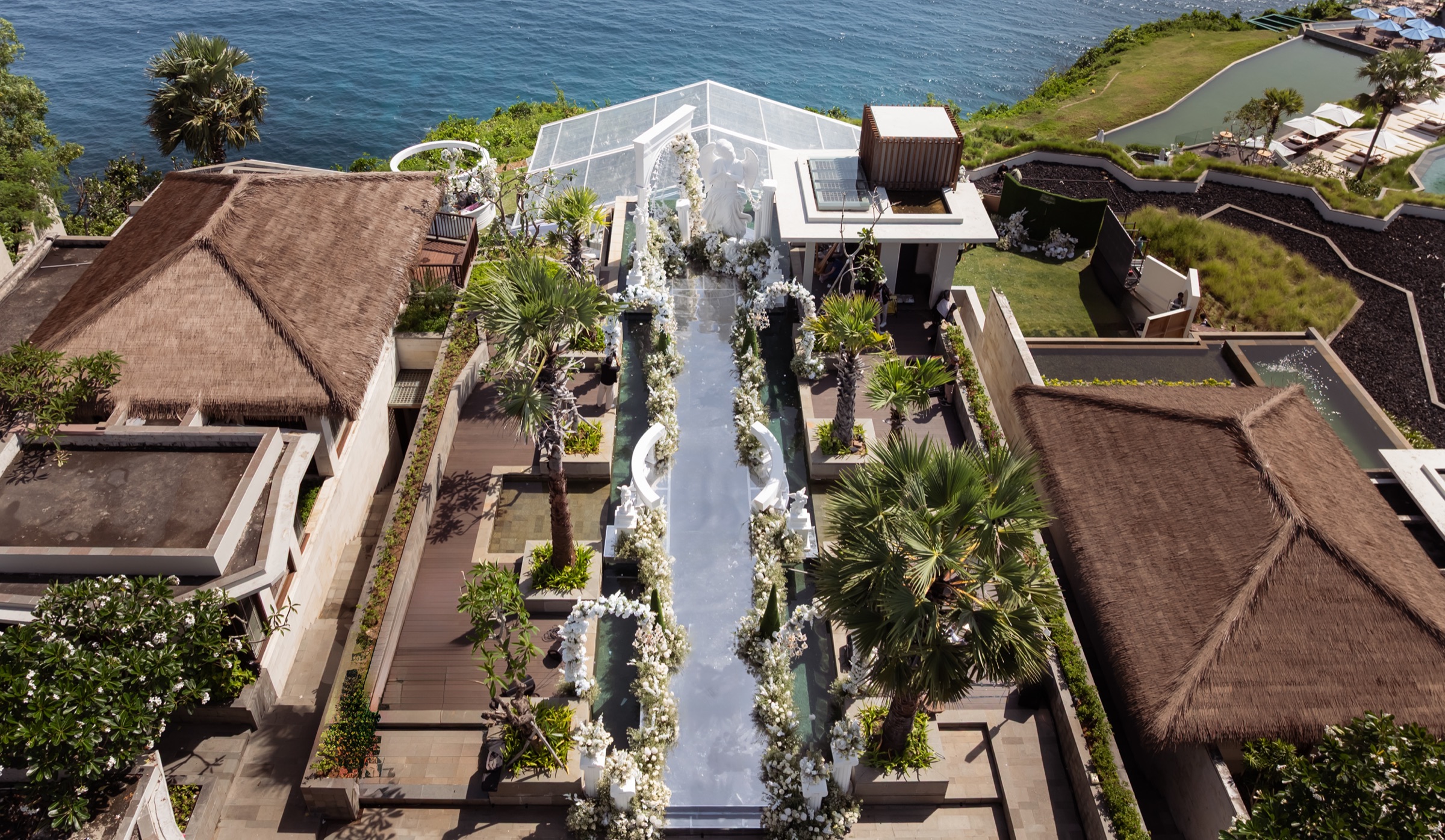 A cliff-top wedding venue in Bali from above, the glass aisle and the sea